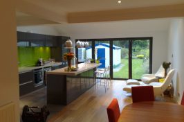 Kitchen with wooden under floor heating looking out into the garden